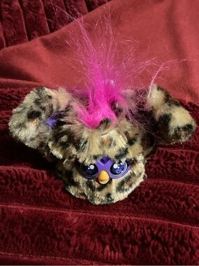 Leopard-Print Plush Toy with Pink Mohawk and Purple Face